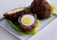 <div class="caption-credit"> Photo by: Photo by Kimberley Hasselbrink</div><b>Japanese-Style Scotch Eggs</b> <br> <br> Season ground beef with soy sauce. Mix in beaten eggs to make a sticky mixture. Flatten about 1/3 cup of the meat mixture in the palm of one hand. Place a floured hard-boiled egg in the center and wrap with the meat mixture to enclose. Dust the meat-covered eggs with cornstarch and deep-fry in vegetable oil until browned and the meat is cooked through, 8 to 10 minutes.