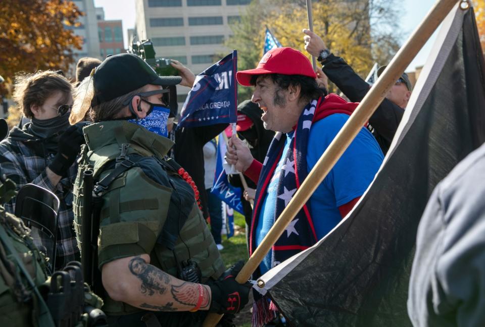 A Trump supporter shouts down counter-protesters outside the Michigan State Capitol building.