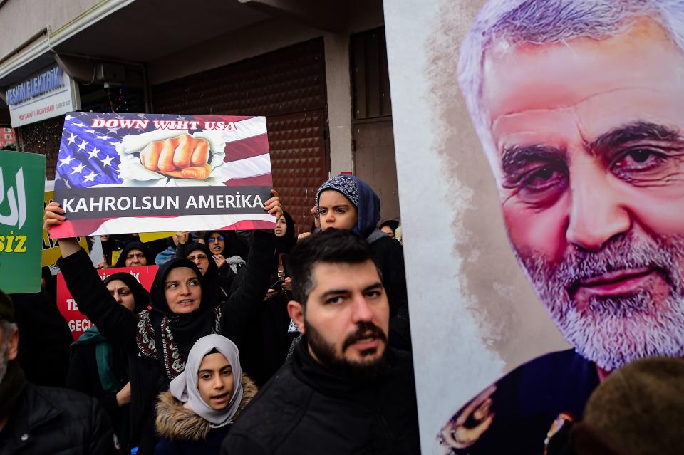 A protester holds a banner reading " down with America", during a demonstration outside the US consulate in Istanbul, on January 5, 2020, two days after top Iranian commander Qasem Soleimani was killed by a US drone strike. - A US drone strike killed top Iranian commander Qasem Soleimani at Baghdad's international airport on January 3, dramatically heightening regional tensions and prompting arch enemy Tehran to vow "revenge". (Photo by Yasin AKGUL / AFP) (Photo by YASIN AKGUL/AFP via Getty Images)