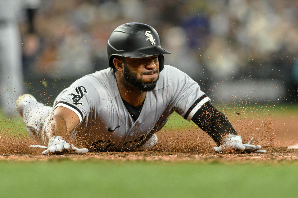 Chicago White Sox's Elvis Andrus slides home to score off a single by Zach Remillard during the ninth inning of a baseball game against the Seattle Mariners, Saturday, June 17, 2023, in Seattle. (AP Photo/Caean Couto)