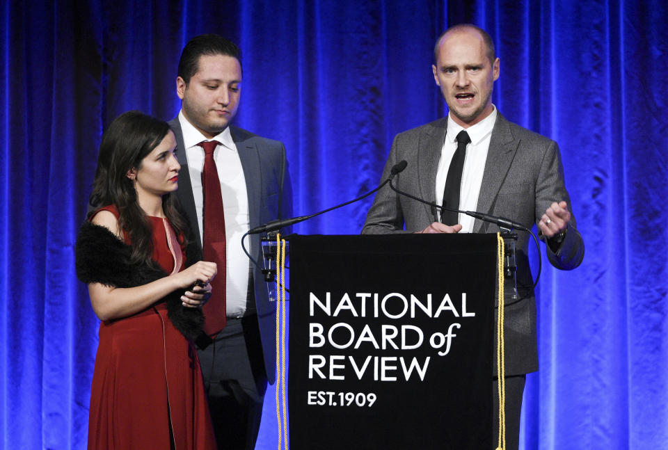 Waad al-Kateab, left, Hamza al-Kateab and Edward Watts accept the National Board of Review freedom of expression award for "For Sama". (Photo by Evan Agostini/Invision/AP)