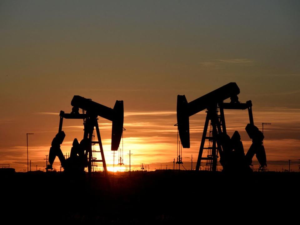 FILE PHOTO: Pump jacks operate at sunset in an oil field in Midland