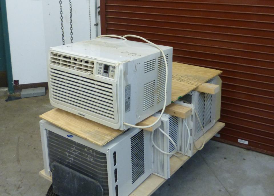 Air conditioners await delivery by Elder Care volunteers to seniors in need of relief during the summer heat.