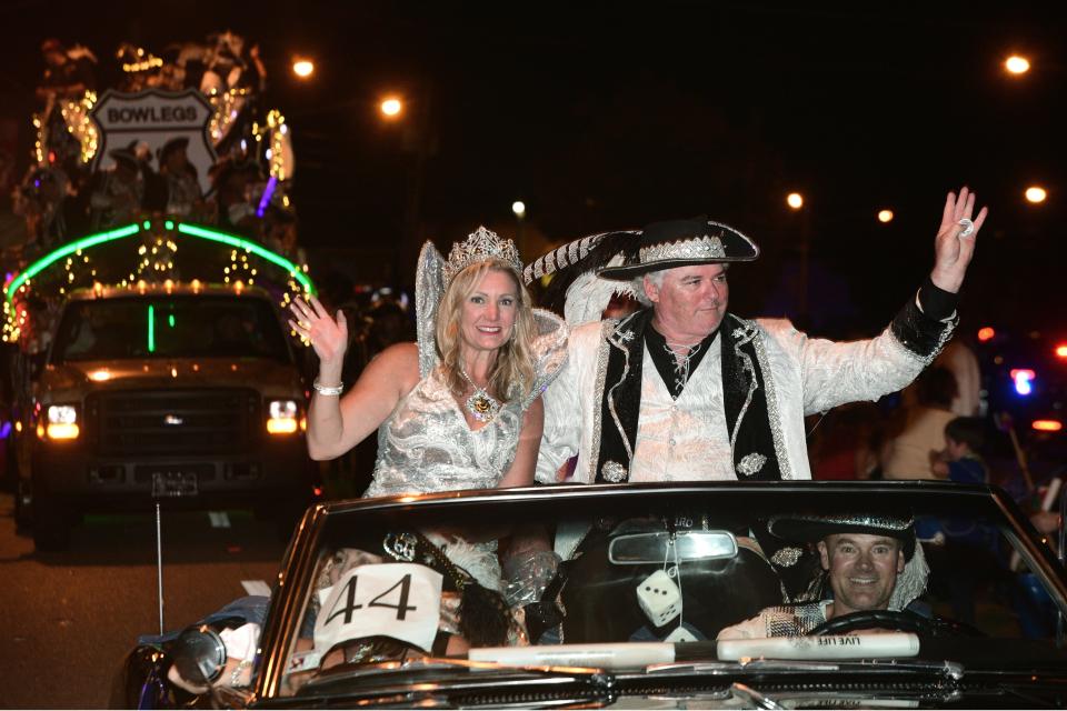 Capt. Billy Bowlegs LVI Gary McMorrow and Queen Whitney Smith wave to people during Monday night's Torchlight Parade along Eglin Parkway in Fort Walton Beach.