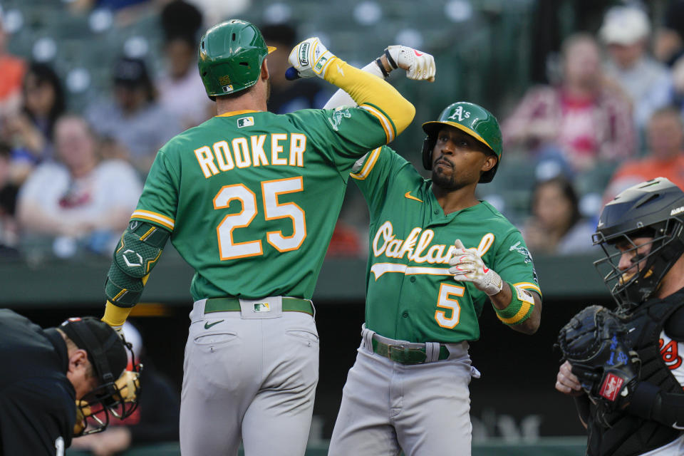 Oakland Athletics' Brent Rooker (25) celebrates with Tony Kemp (5) after hitting a home run against the Baltimore Orioles during the first inning of a baseball game Wednesday, April 12, 2023, in Baltimore. (AP Photo/Jess Rapfogel)