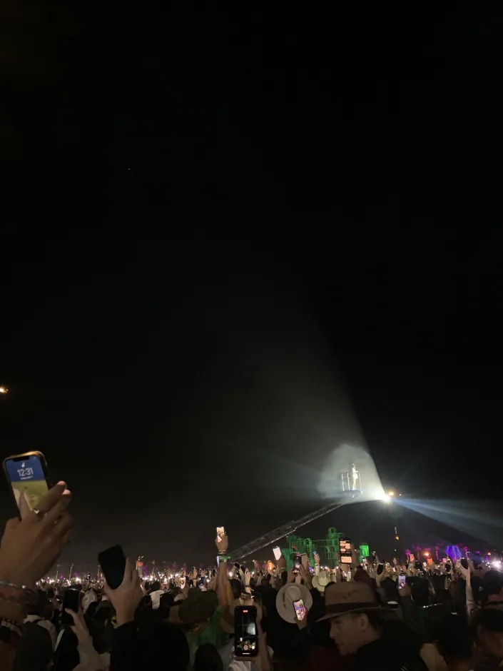 Billie Eilish performing on a raised crane during her Saturday-night set over the crowd