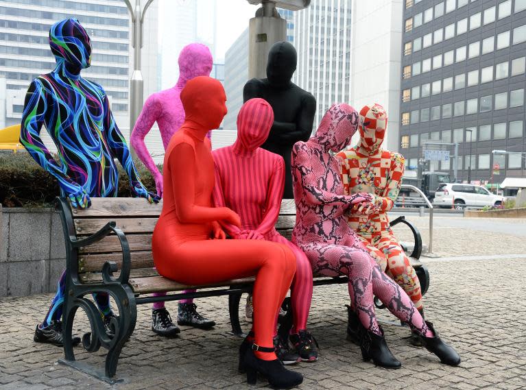 Members of the Tokyo Zentai Club, who wear head-to-toe skintight Lycra, chat at a park in Tokyo, January 25, 2014