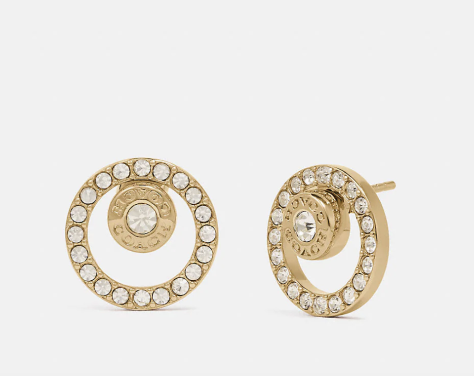 Open Circle Halo Stud Earrings in gold and diamond studs (Photo via Coach Outlet)