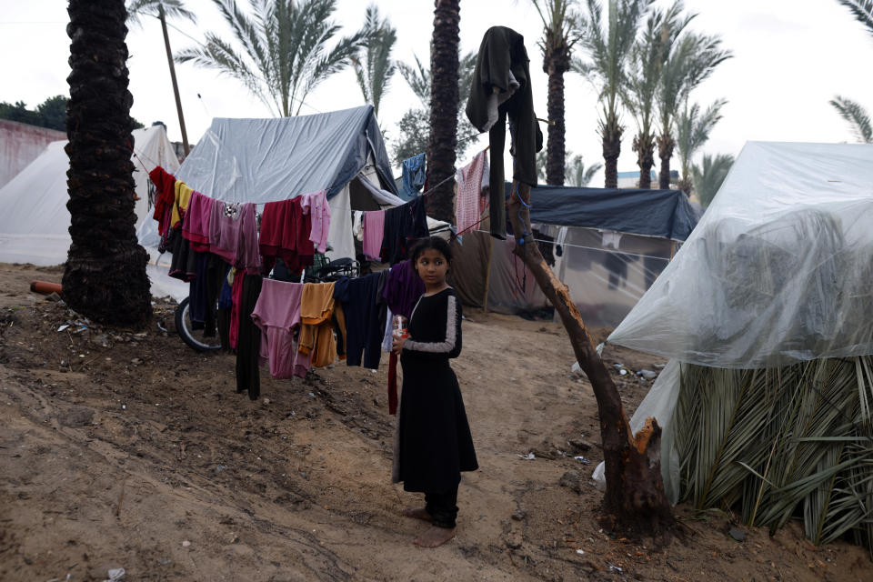 Palestinians displaced by the Israeli bombardment of the Gaza Strip are seen in tents in town of Khan Younis, Wednesday, Dec. 13, 2023. (AP Photo/Mohammed Dahman)