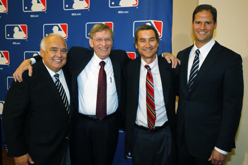 Major League Baseball Commissioner Bud Selig, second from left, joins members of a group approved to buy the San Diego Padres, from left, Ron Fowler, Peter Seidler and Kevin O'Malley after a meeting of baseball owners in Denver on Thursday, Aug. 16, 2012. Fowler, the chief executive of Liquid Investments, will become the controlling owner of the franchise if the purchase price of around $800 million is accepted by current Padres owner John Moores. (AP Photo/David Zalubowski)