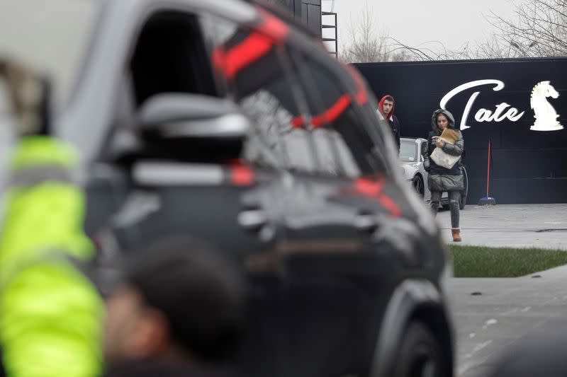 Romanian officials transport the cars seized from Andrew Tate's compound to a storage location