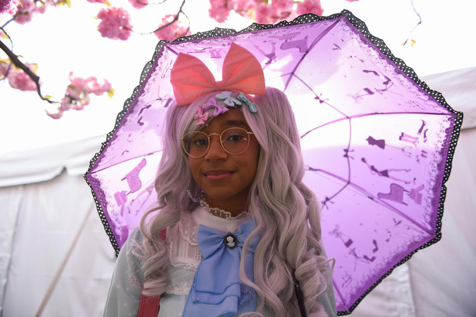 Woman holding parisol at Lolita-style fashion show