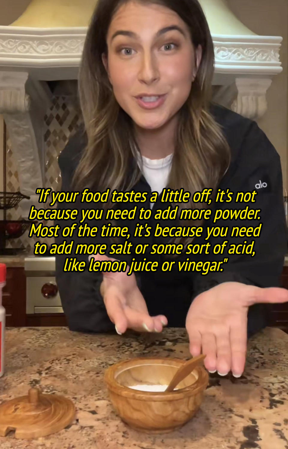 Zoe pointing to salt in video and saying "if your food tastes a little off, it's not because you need to add more powder; most of the time you need more salt or some sort of acid, like lemon juice or vinegar"