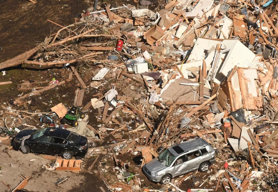 Cars were damaged and were seen sitting on the pile of debrisAP