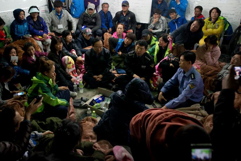 Coastguard police chief Kim Seouk Gyun (bottom C), vice coastguard police chief Choi Sang Han (bottom R), and minister of Oceans and Fisheries Lee Ju Young (bottom L) attend a meeting with relatives of victims of the 'Sewol' ferry on April 24, 2014