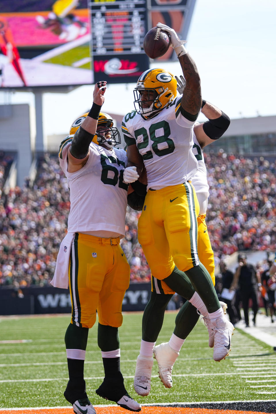 Green Bay Packers running back A.J. Dillon (28) celebrates a touchdown against the Cincinnati Bengals with guard Lucas Patrick (62) in the first half of an NFL football game in Cincinnati, Sunday, Oct. 10, 2021. (AP Photo/AJ Mast)