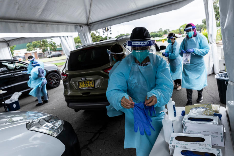 Health workers carry out COVID-19 testings at the Merrylands drive-through clinic in Sydney, Australia.