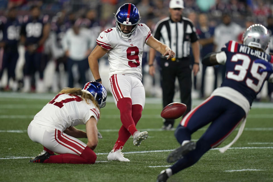 New York Giants' Graham Gano (9) kicks the winning field goal from the hold of Jamie Gillan, as New England Patriots cornerback Terrance Mitchell (39) defends during the second half of a preseason NFL football game, Thursday, Aug. 11, 2022, in Foxborough, Mass. The Giants won 23-21. (AP Photo/Charles Krupa)