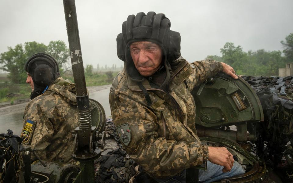 Ukrainian soldiers on a tank ride along the road towards their positions near Bakhmut, Donetsk region, Ukraine