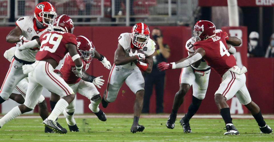 Georgia running back Zamir White (3) runs for a first down against Alabama  during the first quarter of their 2020 game at Bryant-Denny Stadium.