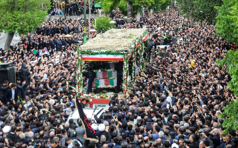 Mourners crowd around the funeral truck in Tabriz, Iran on Tuesday.