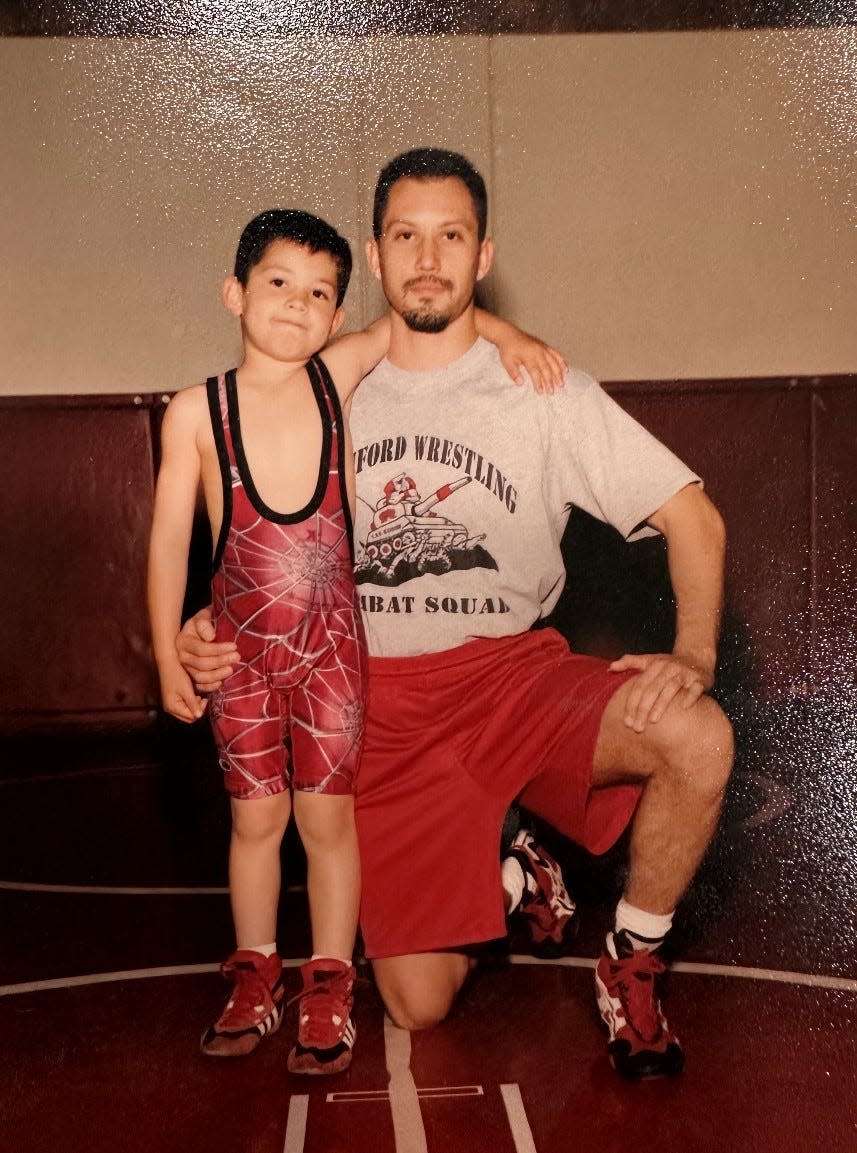 The Wright family, dad Michael and son Michael II, pose for a photo.