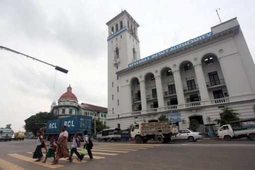 People are seen crossing a road in front of the 1905-built Myanmar Port Authority building in downtown Yangon. As a property boom triggers a flurry of construction activity in Yangon, the race is on to save the former colonial capital's architectural heritage from the wrecking ball