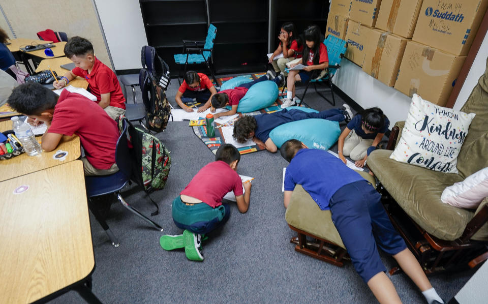 Students works on their memory books during the last week of classes at Frye Elementary School in Chandler, Arizona Tuesday, May 23, 2023.(AP Photo/Darryl Webb)