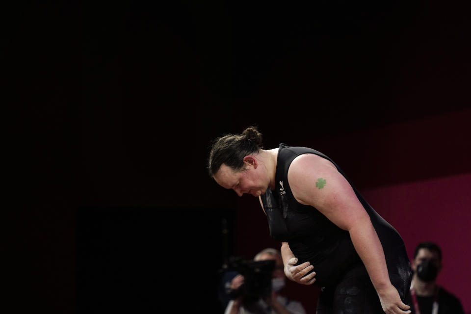 Laurel Hubbard of New Zealand says "Thank you" and bows after lifting, in the women's +87kg weightlifting event at the 2020 Summer Olympics, Monday, Aug. 2, 2021, in Tokyo, Japan. (AP Photo/Seth Wenig)