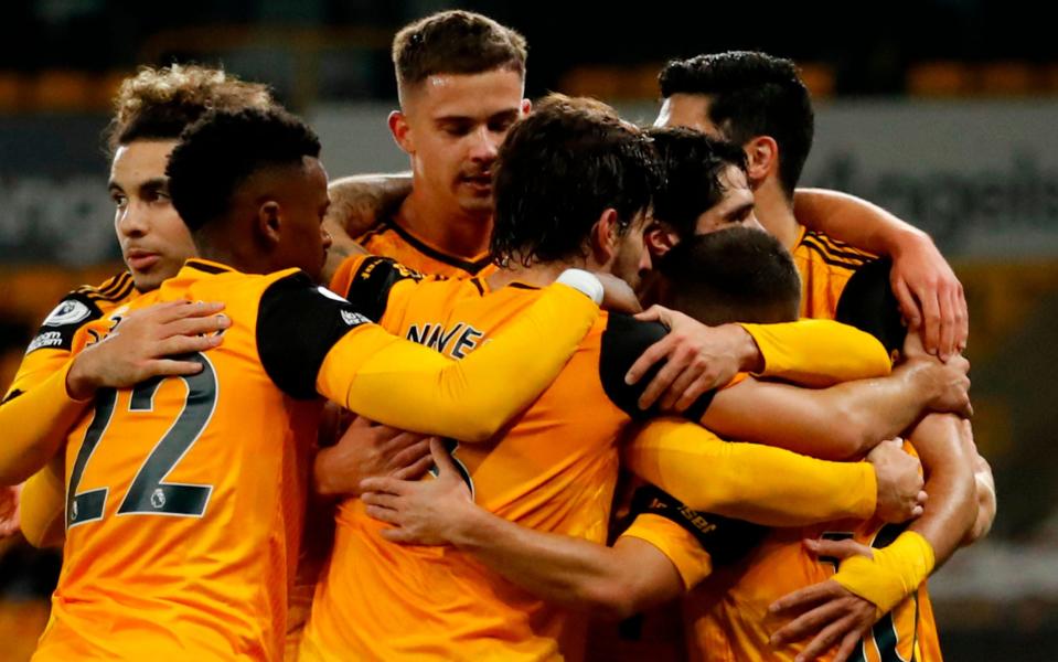 Wolverhampton Wanderers' Portuguese midfielder Daniel Podence (R) celebrates with team-mates after scoring their second goal during the English Premier League football match between Wolverhampton Wanderers and Crystal Palace at the Molineux stadium in Wolverhampton, central England on October 30, 2020. - AFP