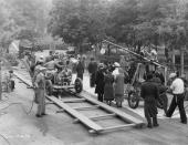 <p>As Hollywood has evolved, so too has the filmmaking industry. In order to shoot moving cars in the mid-1900s, film crews had to build tracks, as pictured here.</p>