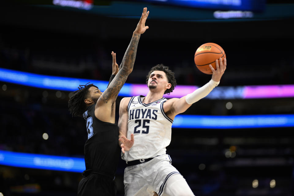 Georgetown forward Ismael Massoud (25) goes to the basket against Marquette forward David Joplin, left, during the second half of an NCAA college basketball game, Saturday, Feb. 3, 2024, in Washington. (AP Photo/Nick Wass)