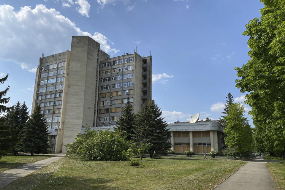 A man walks in front of the National Scientific Center "Kharkov Institute of Physics and Technology" in Kharkiv, Ukraine, Thursday, May 18, 2023. Institute staff say radiation could spread for 6 miles (10 kilometers), covering an area home to 640,000 people. (AP Photo/Oleksandr Brynza)