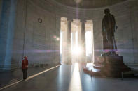 <p>A tourist reads the inscriptions carved on the walls of the Jefferson Memorial as the early-morning sun flares through the columns during the Presidents’ Day holiday, Feb. 20, 2017, in Washington, D.C. (AP Photo/J. David Ake) </p>