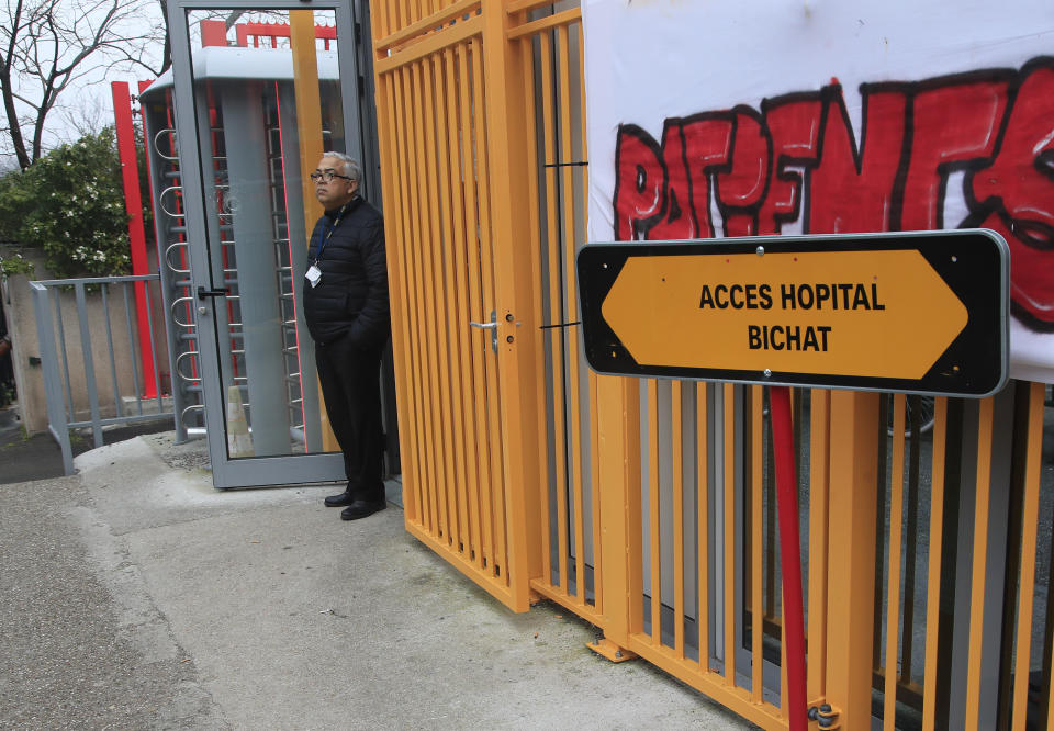 A man stands in the entrance door of the Bichat hospital in Paris, Saturday Jan. 25, 2020. France has announced three confirmed cases of the deadly new virus from China, the first cases in Europe and the first outside Asia and the United States. One of people who caught the virus is hospitalized in the southwestern city of Bordeaux. The others are in Paris. (AP Photo/Michel Euler)