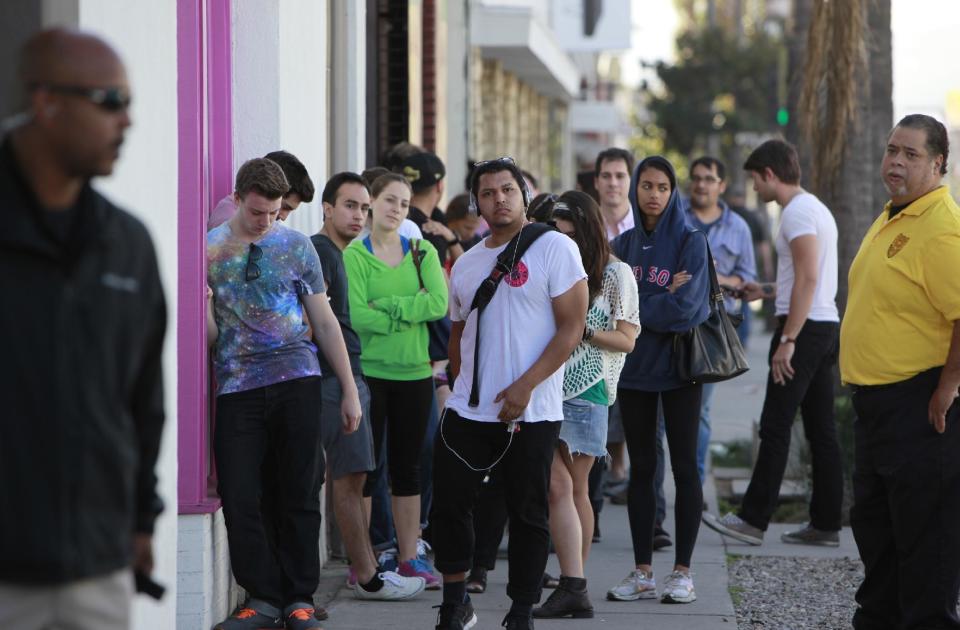 Visitors form a line to enter an exhibition called "#IAMSORRYTOO" by actor Jerry O'Connell at Artspace Warehouse in Los Angeles on Wednesday, Feb. 12, 2014. Inside, O'Connell donned a paper bag with the words "SUPER FAMOUS" on it. Actor Shia LaBeouf began his planned seven-hour, seven-day stint inside the Stephen Cohen Gallery next to Artspace Warehouse on Tuesday, Feb. 11, 2014, seated at a small table, wearing a disheveled tuxedo and the paper bag with some eye holes cut out and the words "I AM NOT FAMOUS ANYMORE" scrawled in black ink across it. (AP Photo/Richard Vogel)