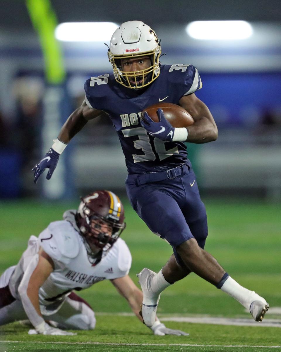 Hoban running back Lamar Sperling rushes for a first down during the first half of a Division II regional championship football game, Friday, Nov. 19, 2021, in Twinsburg, Ohio.