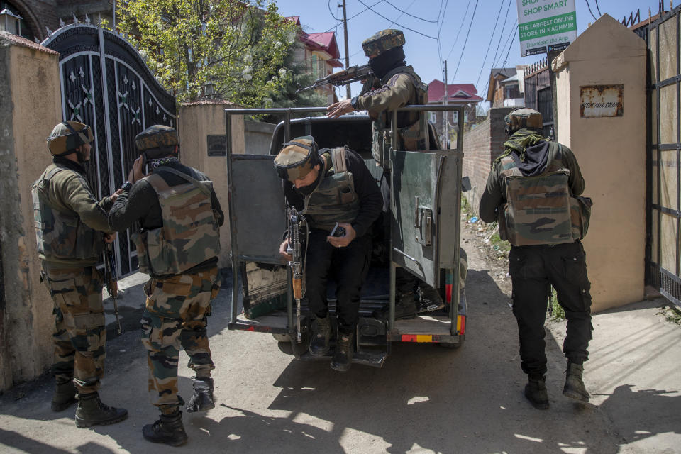 Indian army officers arrive at the site of a shootout on the outskirts of Srinagar, Indian controlled Kashmir, Thursday, April 1, 2021. Gunmen in disputed Kashmir on Thursday killed a policeman as they tried to storm the residence of a politician of India's ruling party, police said. (AP Photo/ Dar Yasin)