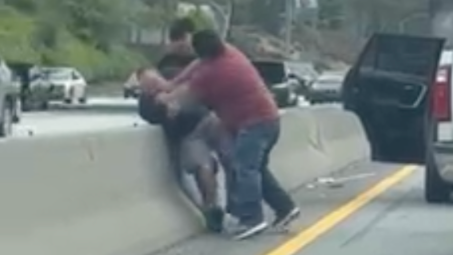 A motorist is seen restrained and struck by two people on the 10 Freeway in Santa Monica on April 23, 2024.