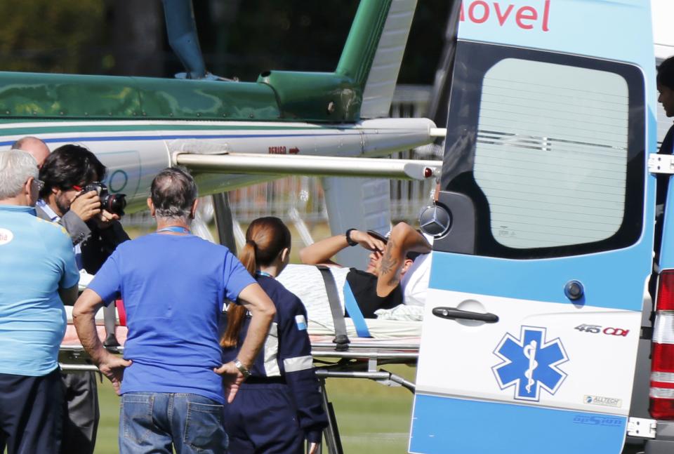 Brazil's Neymar is transported from an ambulance to a military helicopter to be airlifted home from Brazil's training camp inTeresopolis near Rio de Janeiro July 5,2014. REUTERS/Marcelo Regua