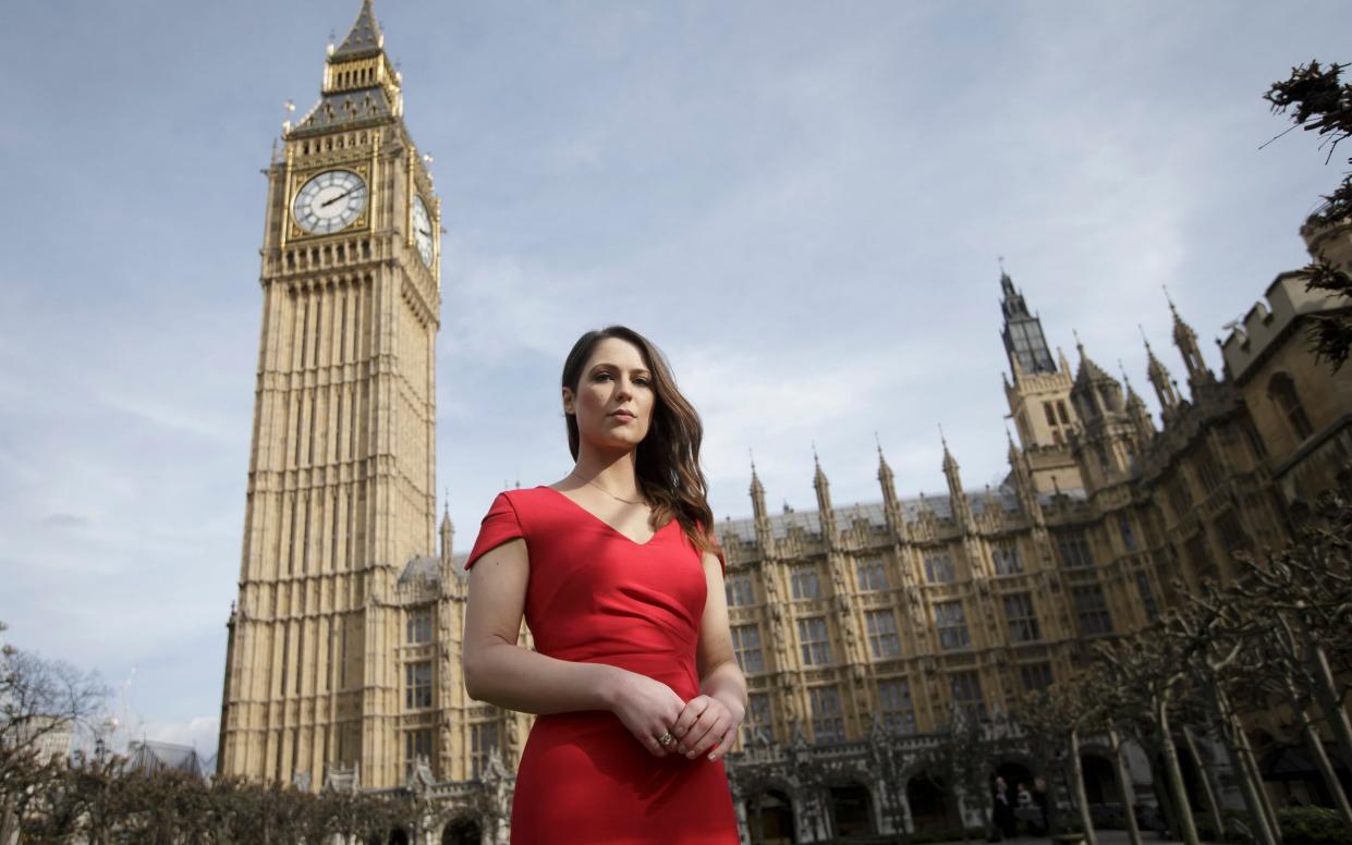 The lead campaigner for a high heels ban Nicola Thorp stands outside the Houses of Parliament - AP