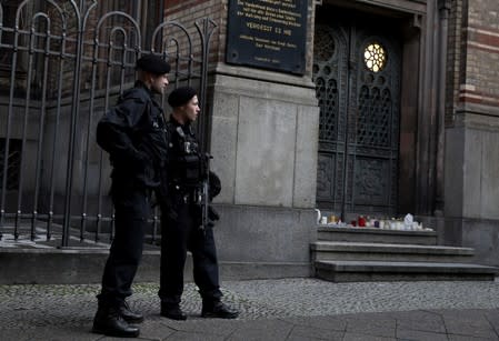 Police officers stand guard in front of the entrance to the Neue Synagoge in Berlin