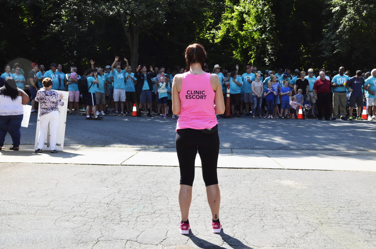 A volunteer clinic escort and member of Pro-choice Charlotte waits in the clinic parking lot to direct patients past throngs of protesters at a protest in Charlotte, North Carolina in June 2017. (Photo: Jenavieve Hatch/HuffPost)