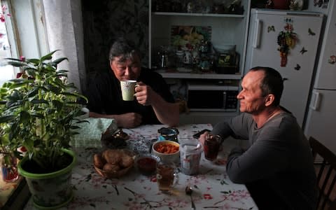 Polar bear patrol leader Eduard Davletshin drinks tea in his kitchen overlooking the Arctic coast - Credit: Alec Luhn/For The Telegraph