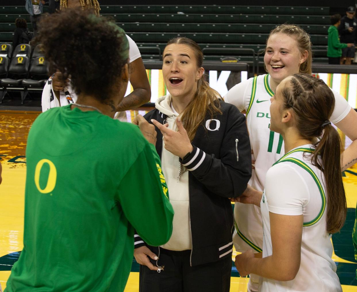 Former Duck Sabrina Ionescu, center, meets with the Oregon women's basketball team after their exhibition game against Southern Oregon at Matthew Knight Arena in October 2023 in Eugene.
