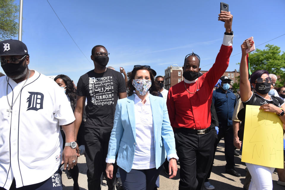 FILE - In this Thursday, June 4, 2020 file photo, Gov. Gretchen Whitmer, center, joins others during a rally in Highland Park, Mich., in honor of George Floyd, a Black man who died the previous week while being arrested by Minneapolis police. On Friday, July 17, 2020, The Associated Press reported on stories circulating online incorrectly asserting that Whitmer, the Democratic governor of Michigan, is the niece of billionaire investor and philanthropist George Soros. A look at the lineages of Whitmer and Soros shows he is not her uncle. (Clarence Tabb, Jr./Detroit News via AP)