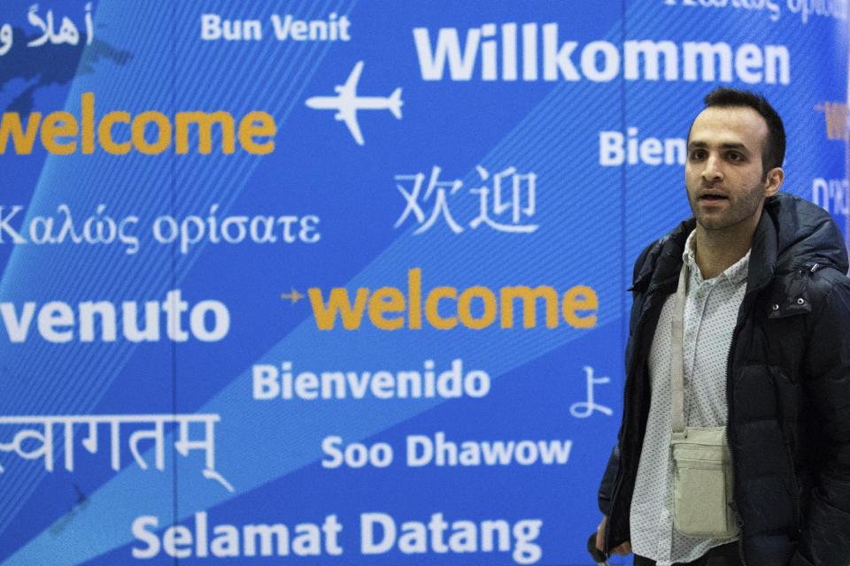 Iranian bioengineering researcher Nima Enayati walks out of a gate after arriving at John F. Kennedy International Airport in New York, Sunday, Feb. 5, 2017. The Ph.D. candidate at a university in Milan, was prevented from boarding a flight to the U.S. on Jan. 30. He had a visa to conduct research on robotic surgery at Stanford University in California. (AP Photo/Alexander F. Yuan)