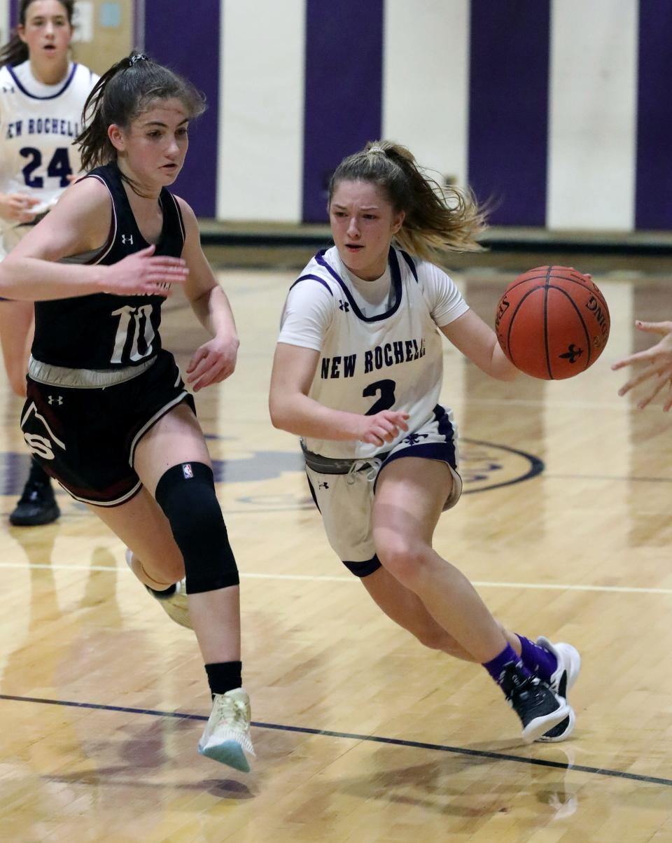 All-section player Rylie Rosenberg of New Rochelle drives the ball in front of Scarsdale's Ivy Boockvar during the Scarsdale vs. New Rochelle girls basketball game, Jan. 20, 2023, at New Rochelle High School. New Rochelle beat Scarsdale, 40-36.