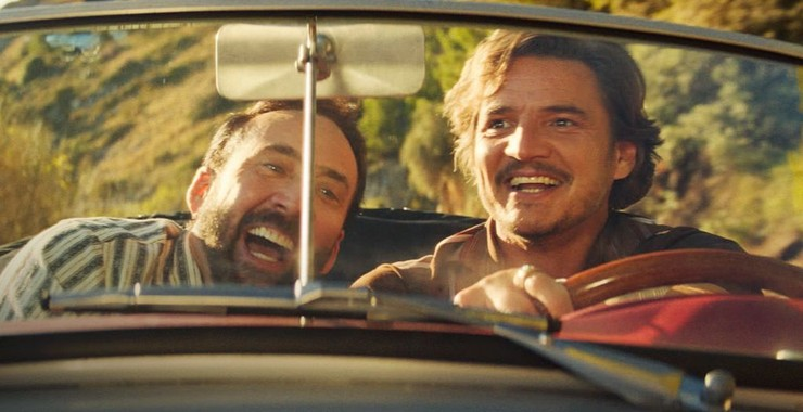Nicholas Cage as Nicholas Cage and Pedro Pascal as Javi Gutierrez in "The Massive Weight of Unbearable Talent." Gutierrez drives a car as the two men laugh.