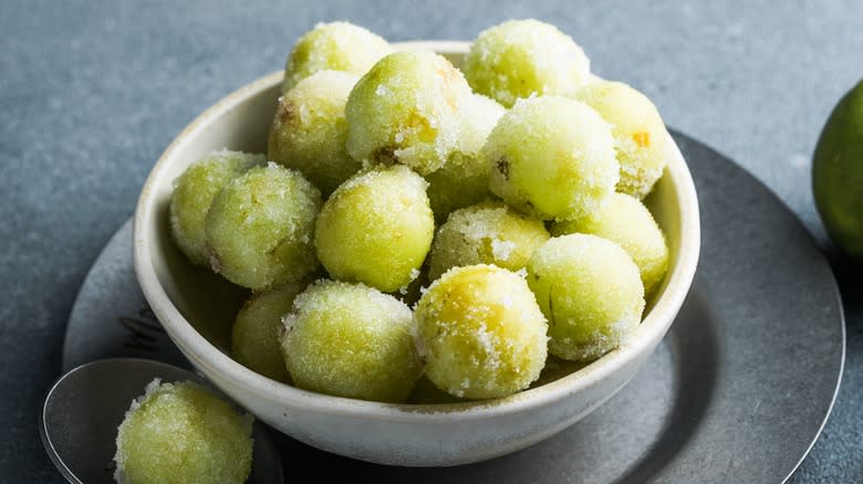 A bowl of frozen green grapes